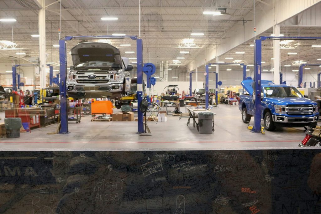 Large auto repair shop with trucks lifted