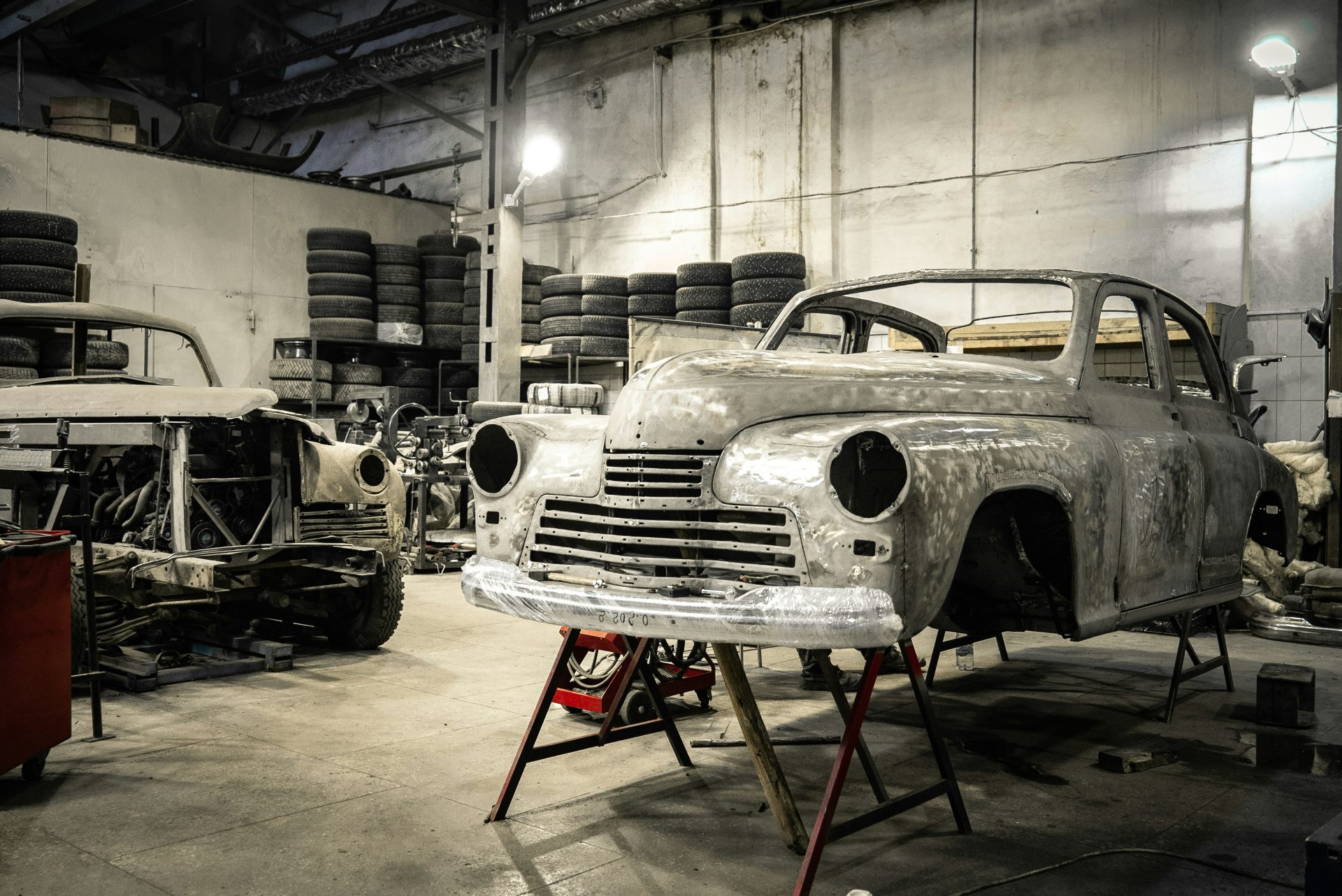 Vintage car being restored in workshop setting